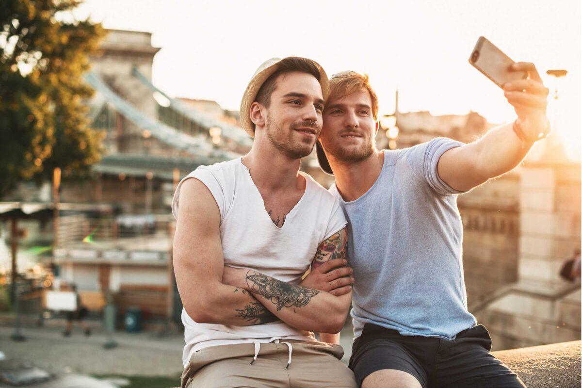 A couple taking a selfie near a city landmark